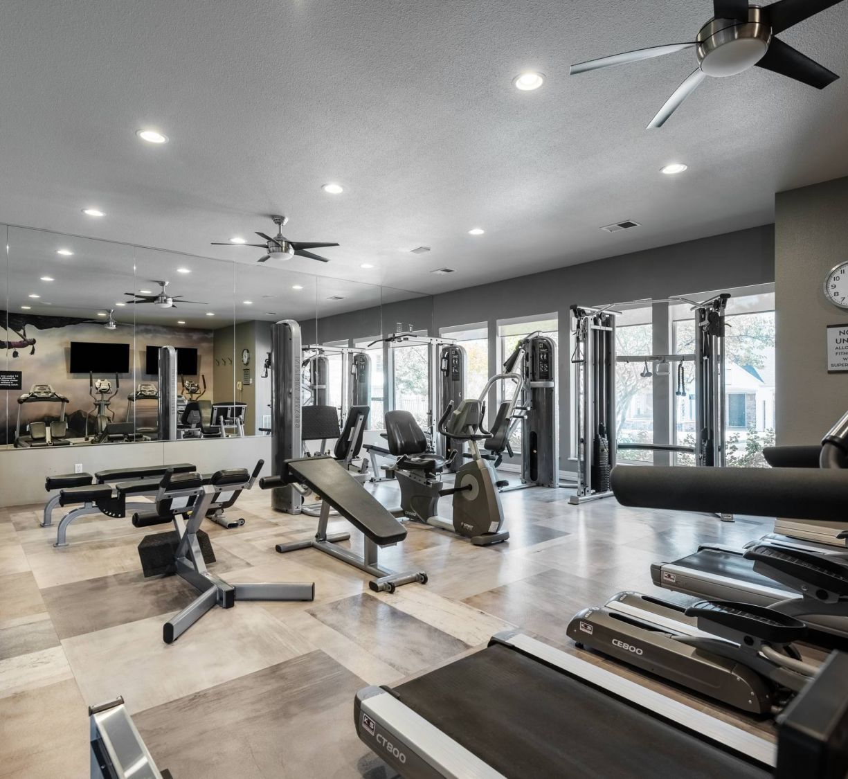 The Windsor community center with high ceilings, large windows, and luxurious furniture and seating